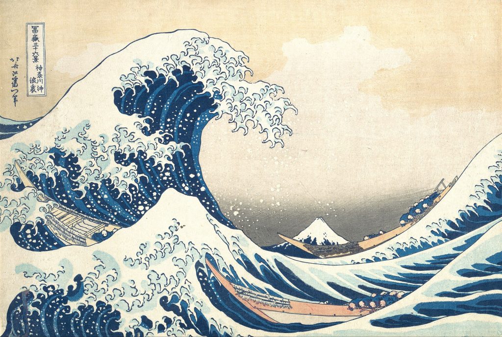 Towering wave with claw-like foam about to crash onto three fishing boats, Mount Fuji small in the distance