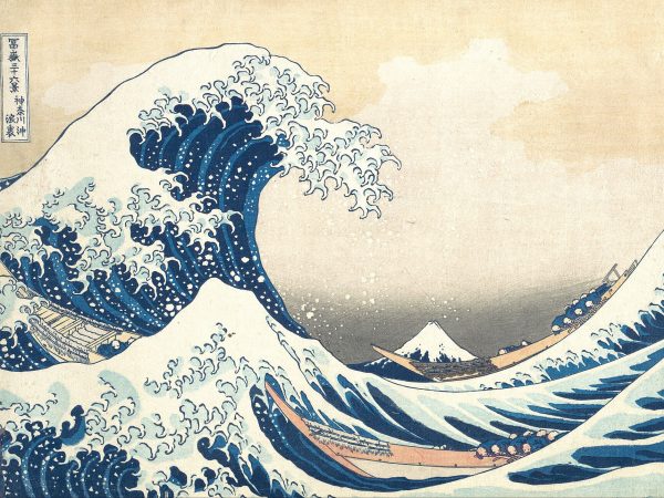 Towering wave with claw-like foam about to crash onto three fishing boats, Mount Fuji small in the distance